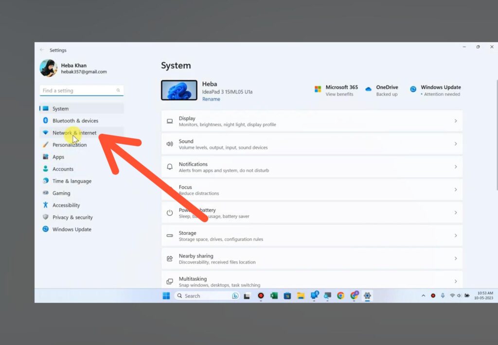 Windows 11 settings home screen with a red arrow pointing to Network and Internet settings